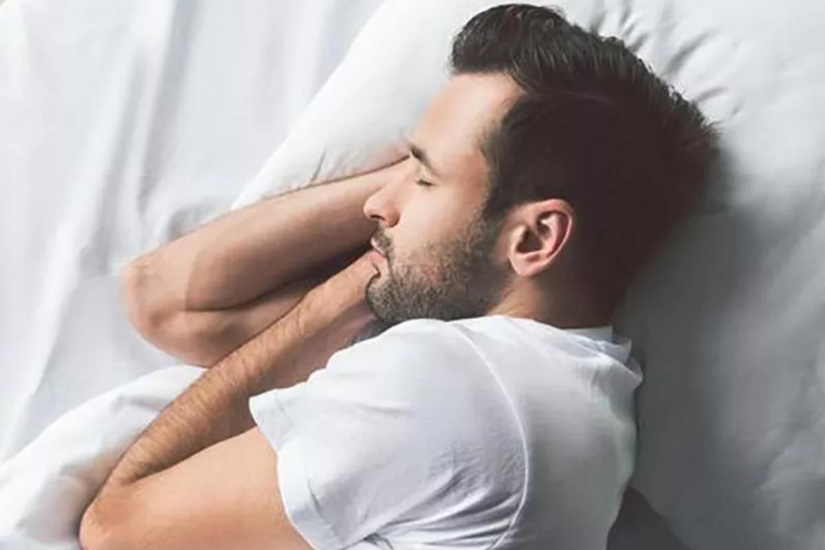 Hombre duerme en la postura adecuada para dormir: de lado.