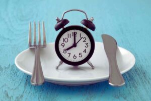 despertador en plato con cubiertos