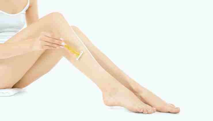 donna che si depila le gambe con rasoio