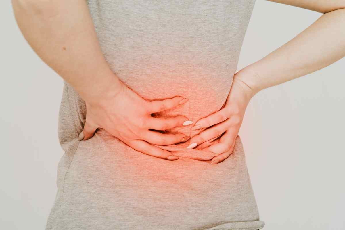 donna che si tocca la schiena per dolore
